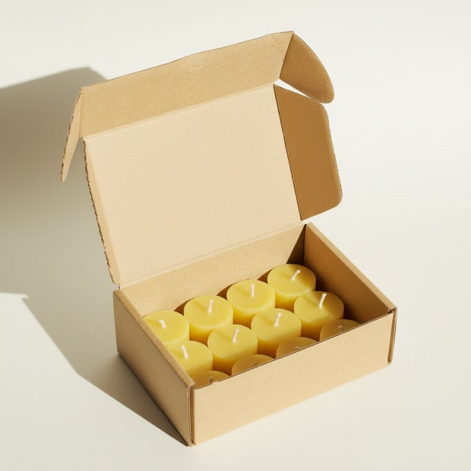 twelve golden beeswax tea lights in their box