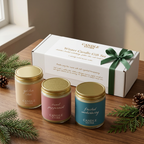 6 oz winter candle gift set with gold lids, white gift box, and green ribbon