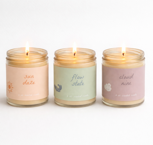 Three naturally scented therapeutic candles with labels on a white background